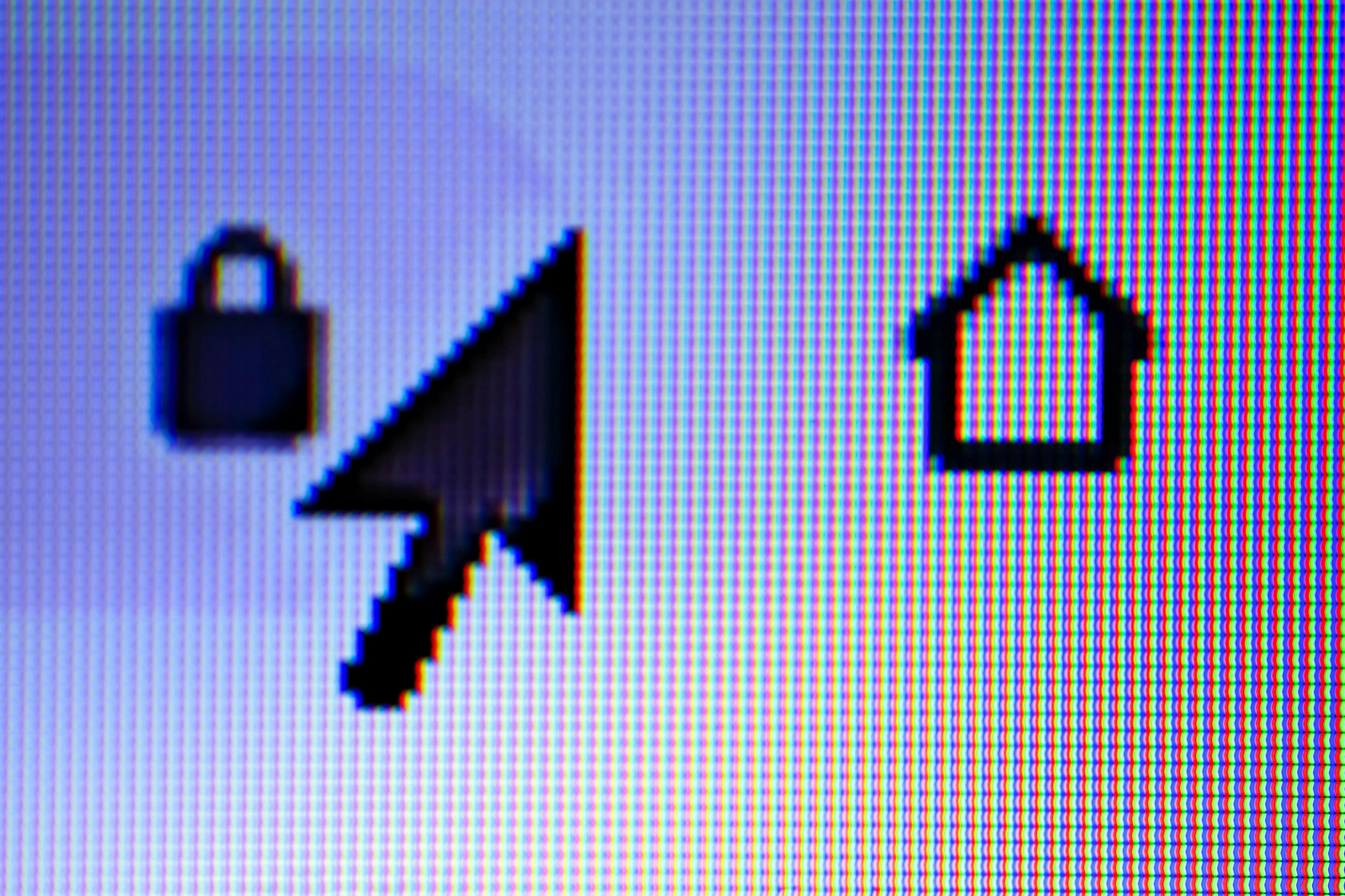 An close-up of a computer screen showing a cursor and the symbols for lock and home.